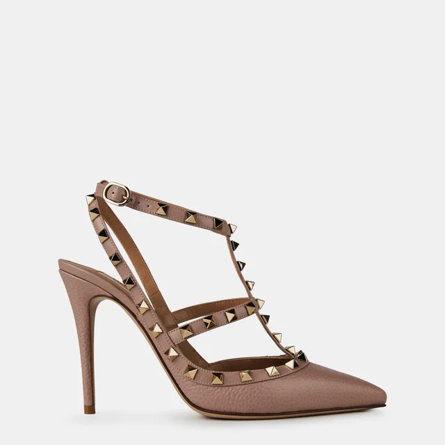 Blush patent-leather Valentino Garavani pump with three studded straps and a stiletto heel, side view against a pale ground