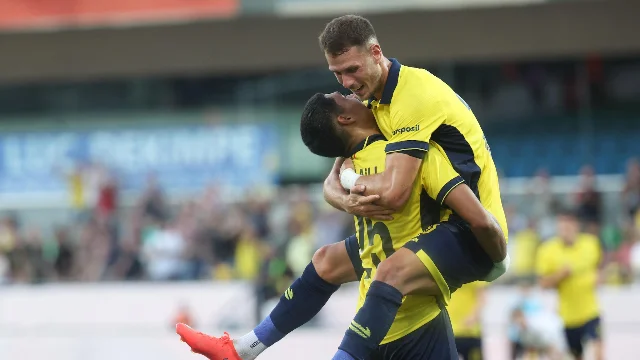 Players celebrate during a UEFA club-competition qualifier