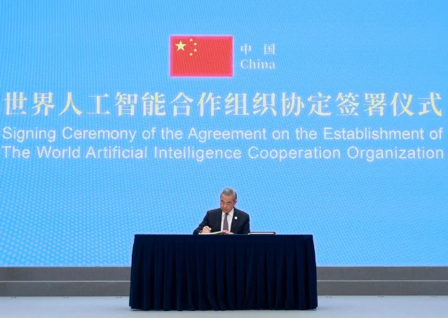 Chinese Foreign Minister Wang Yi signs the WAICO founding agreement at a Shanghai ceremony