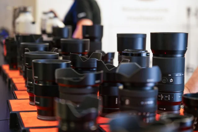 Sony G Master and other E-mount lenses lined up on a display table