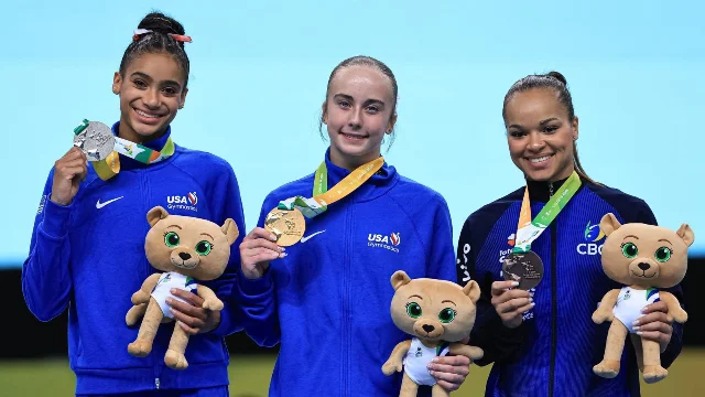 Charleigh Bullock (silver, left), Claire Pease (gold, center), and Brazil's Thais Fidelis (bronze, right) on the all-around podium at the 2026 Pan American Championships