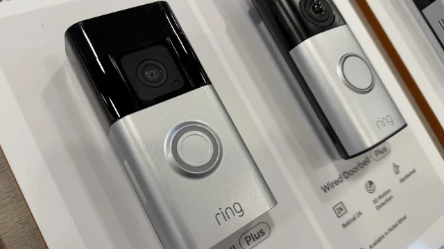 Ring cameras displayed inside a store, including Battery Doorbell Plus and Wired Doorbell Plus models