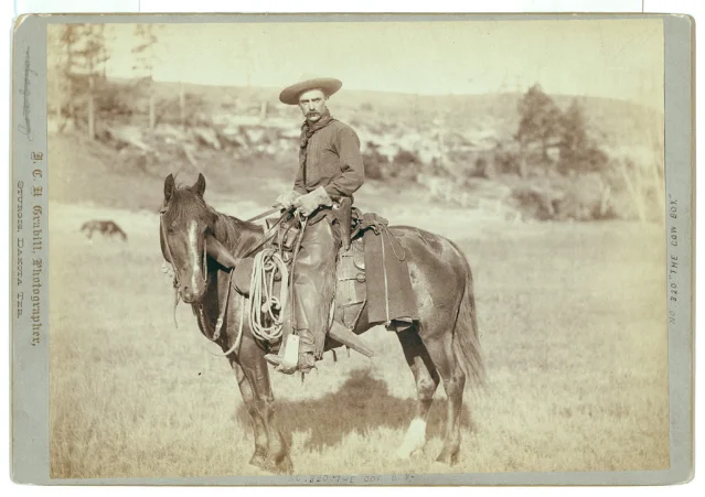 Original black-and-white Grabill photograph of a cowboy on horseback