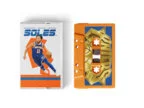 Cassette package variant — orange-shell tape with alternate sleeve design, SOLES branding visible on case
