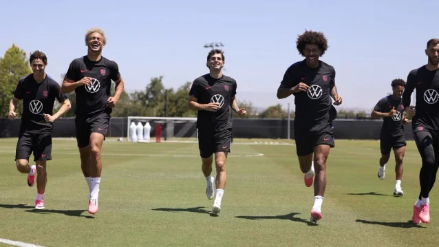 USMNT players jog through a training session
