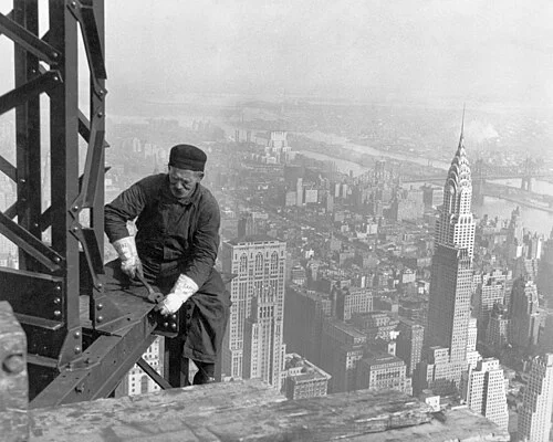 1930 ironworker bolting steel beams during Empire State Building construction