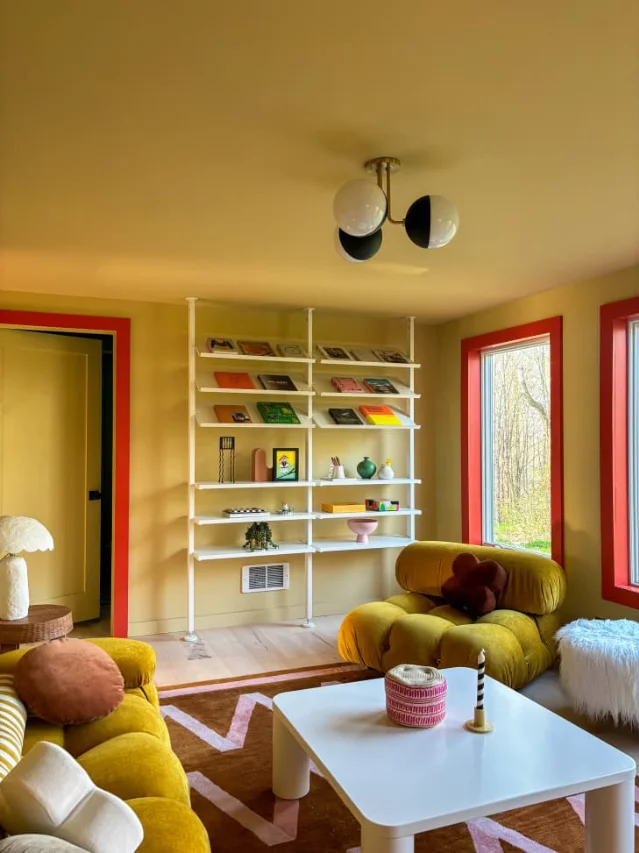 ELVARLI open storage system in white — floor-to-ceiling post-and-shelf unit filling a living room wall