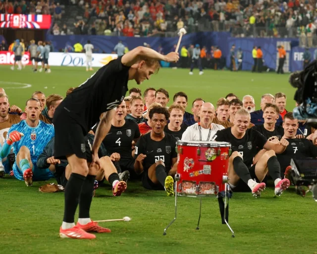 Norway supporters in a Viking-row celebration