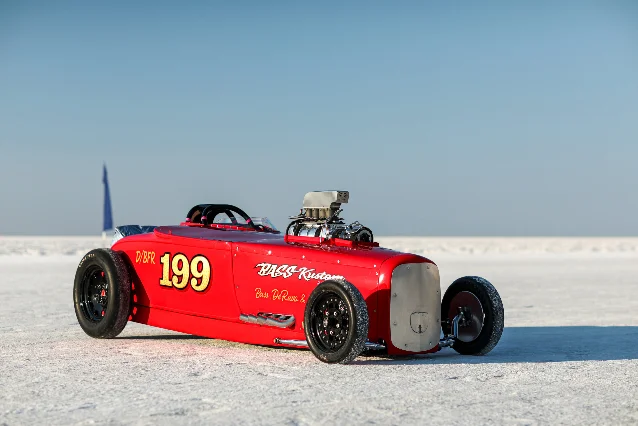 Bright red vintage-style roadster on the Bonneville salt flats