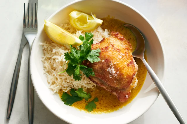 One-Pan Kuku Paka chicken thighs in a skillet with coconut curry sauce
