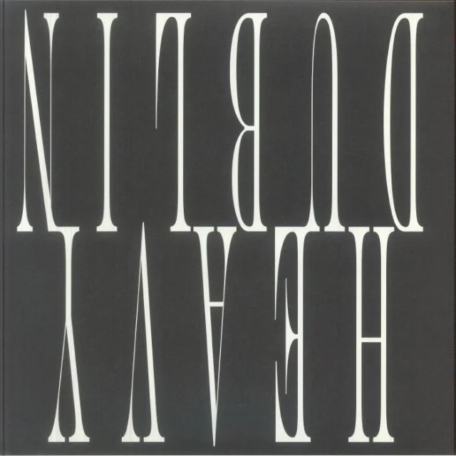 The LP back cover — the words DUBLIN HEAVY printed in large white serif type on a dark grey background, vertically stacked and mirrored so both words read upside down simultaneously
