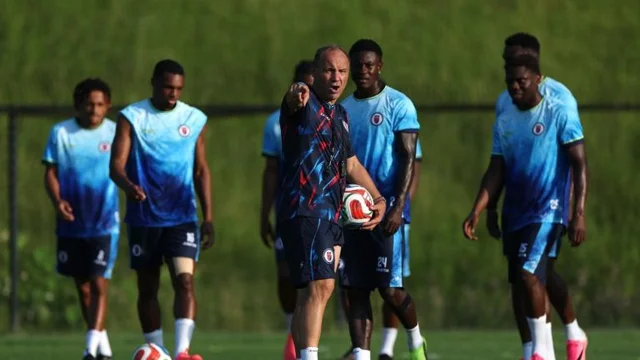 Haiti coach Sebastien Migne talks to players at training
