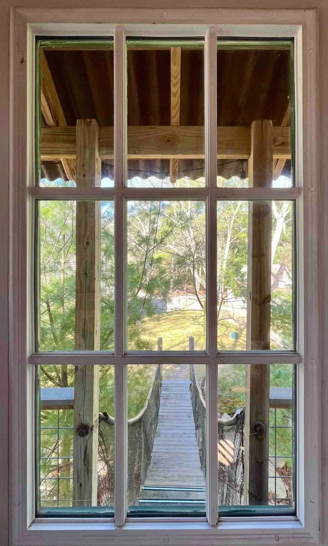 View from inside Mink Cove Treehouse toward the suspension bridge