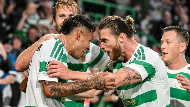 Celtic players celebrate during the Champions League play-off first leg
