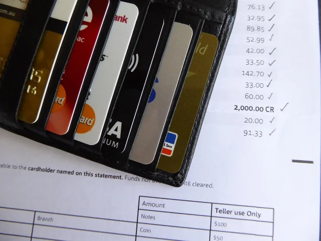 Bank and credit card statements spread out for subscription audit review