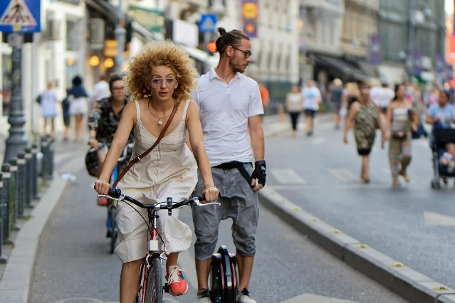 Woman commuting on a city eBike with a step-over diamond frame