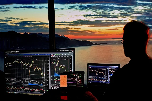 Stock market trading screens displaying financial data and price charts
