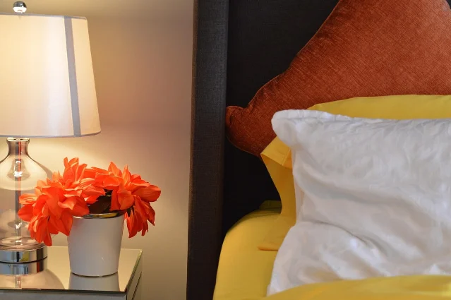 Lamp and flower pot on a bedside table