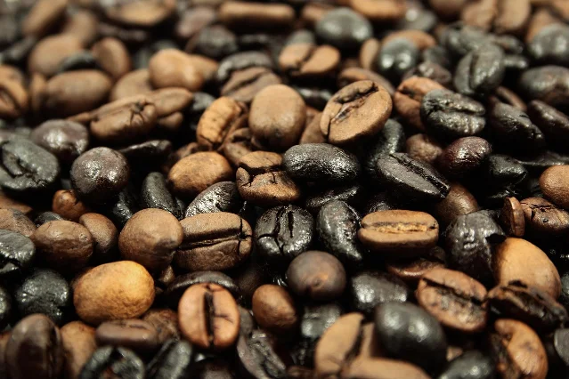Heap of roasted coffee beans filling the frame