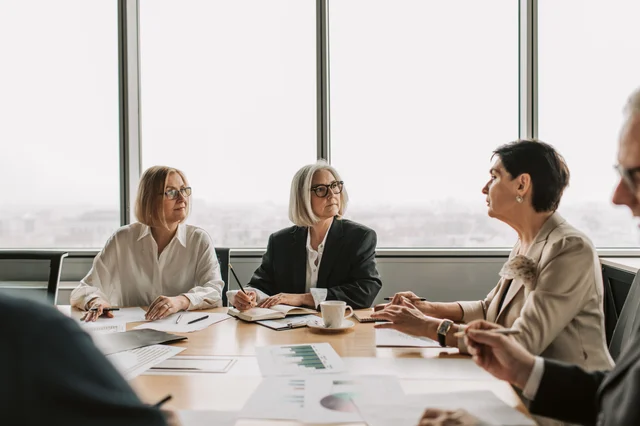 Senior executives in a boardroom — the context where Brown's framework was designed to operate, and where its structural assumptions are most likely to hold