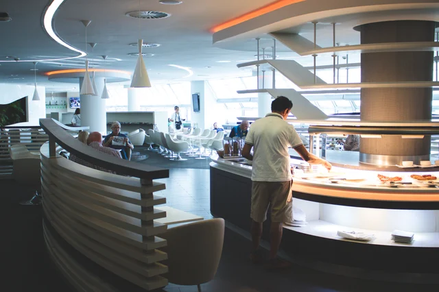 Stylish airport lounge interior with buffet and contemporary seating