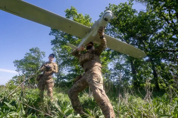 Ukrainian servicemen launch a drone toward Russian positions in the Kharkiv region