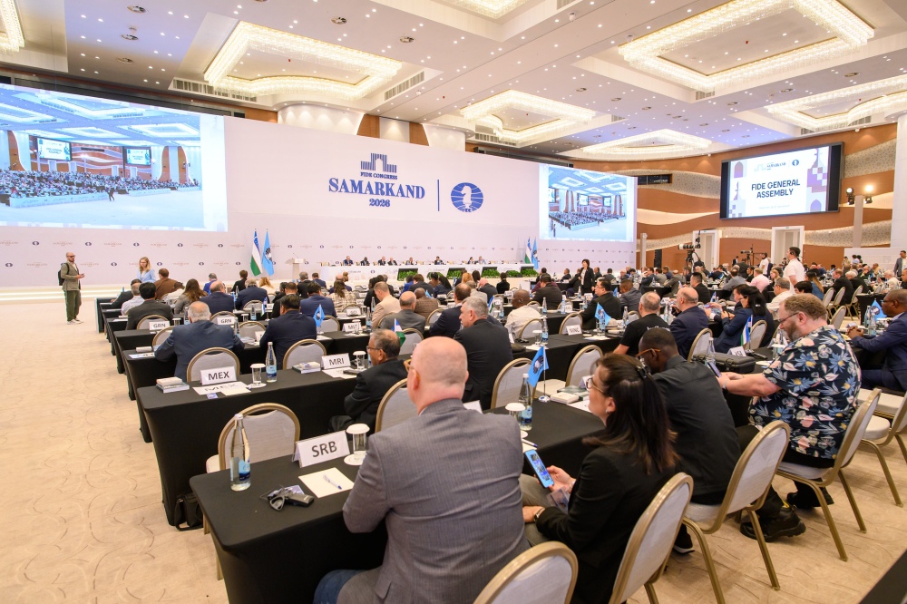 Delegates seated at tables in a large congress hall beneath a Samarkand 2026 backdrop and a FIDE General Assembly screen