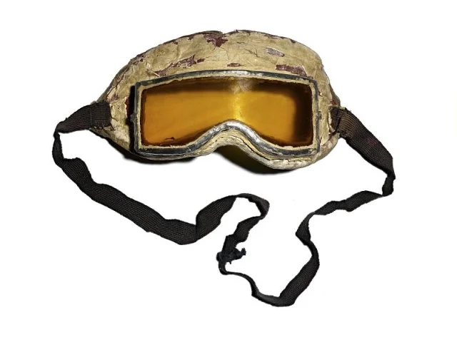 A pair of amber-lensed swimming goggles with a long black strap