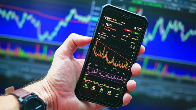 Stock market trading charts on monitor screens