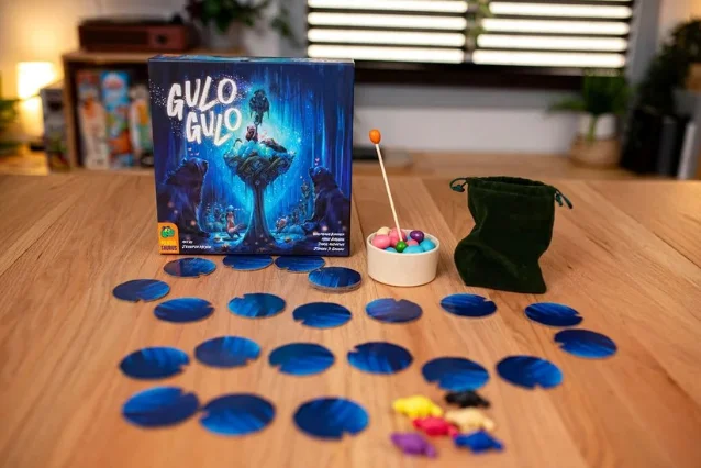 Gulo Gulo game setup showing wooden egg nest, weighted alarm dowel, and linear path