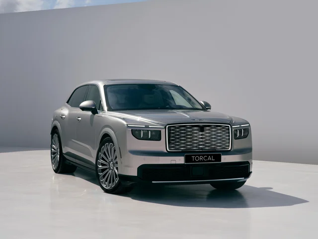 A silver 2028 Bentley Torcal SUV photographed three-quarter front in a studio