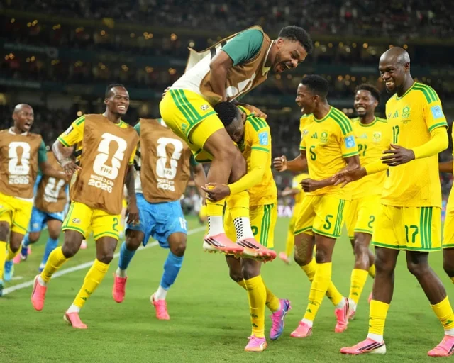 Thapelo Maseko is mobbed after scoring against Korea Republic