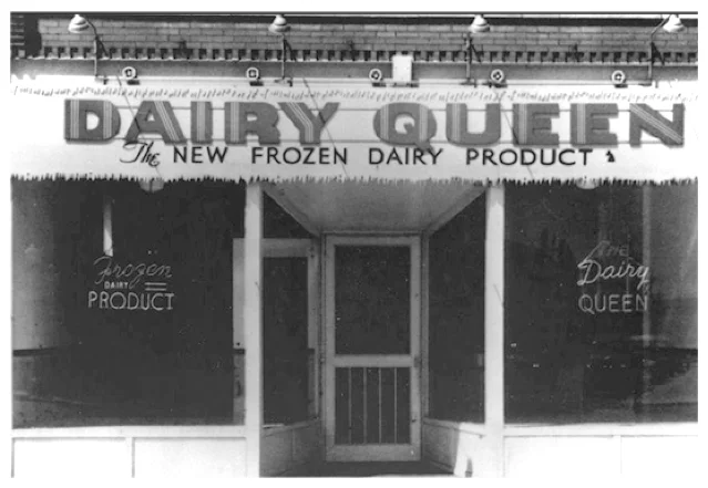 The first Dairy Queen storefront in Joliet, Illinois, 1940 — brick building with large "DAIRY QUEEN, The New Frozen Dairy Product" signage