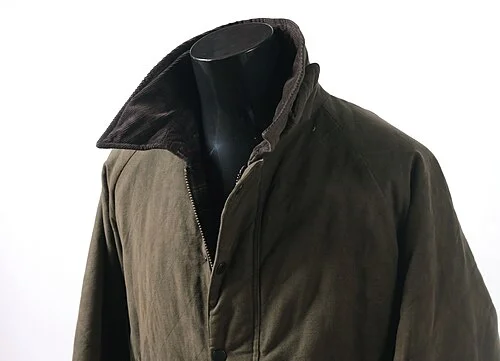 A green waxed cotton Barbour jacket — the design that became synonymous with British countryside style