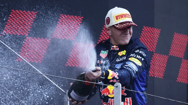 Isack Hadjar sprays champagne on the Monaco podium, his first with Red Bull Racing