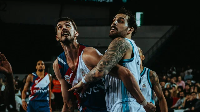 Two basketball players competing in an intense one-on-one moment