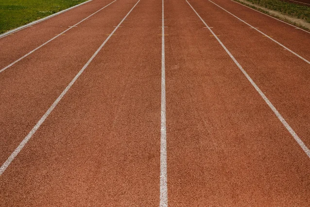 Close-up of a running track with white lane markings
