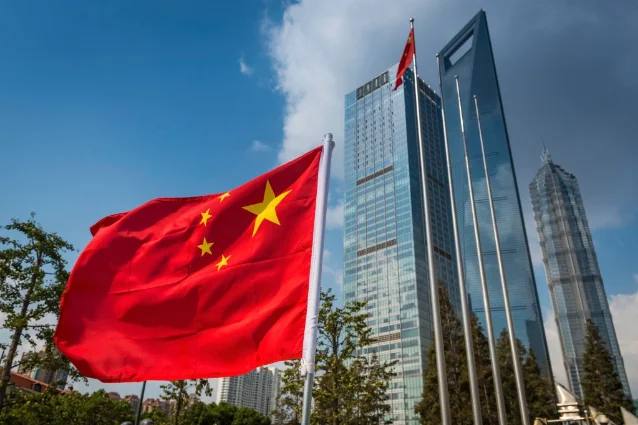 Chinese flag flying beside Pudong skyscrapers