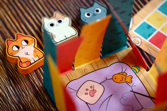 Cat tokens beside folded coloured strands and a Blancat goal card