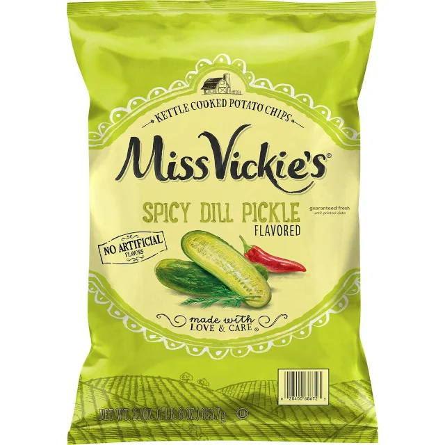 A green 22-ounce bag of Miss Vickie's Spicy Dill Pickle kettle-cooked potato chips, its front panel showing dill pickles, a red chile and a farm field.
