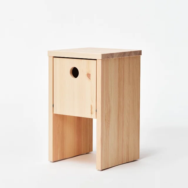 Solid pine IKEA PS 2026 bedside table with built-in cable management visible on the side, compact footprint