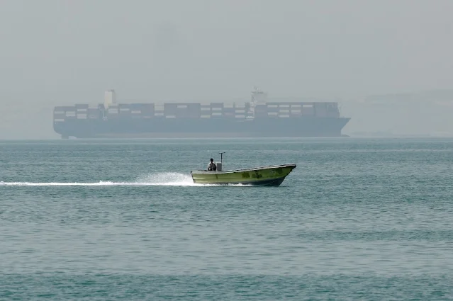 Hormuz Strait — LNG tankers and small vessels navigate the chokepoint