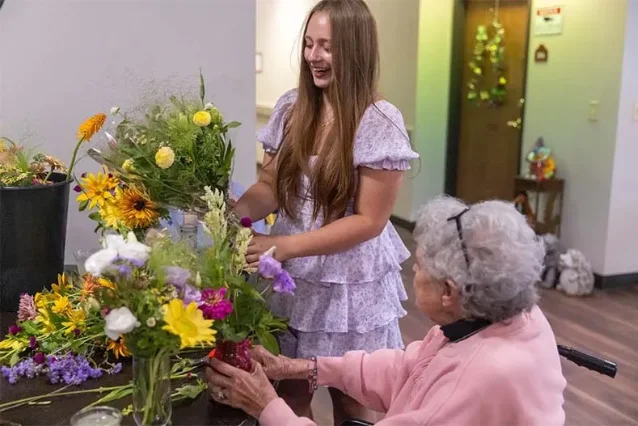 Claire Taylor with a resident.