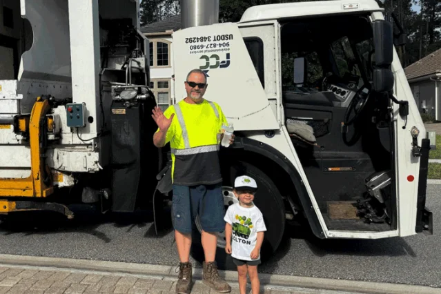 Ben Smith and Colton Simonian beside the recycling truck