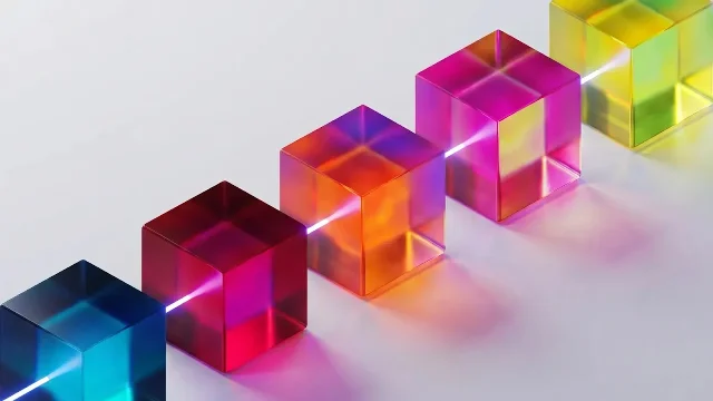 A row of translucent colored glass cubes with white light passing through them, illustrating multi-agent interaction dynamics.
