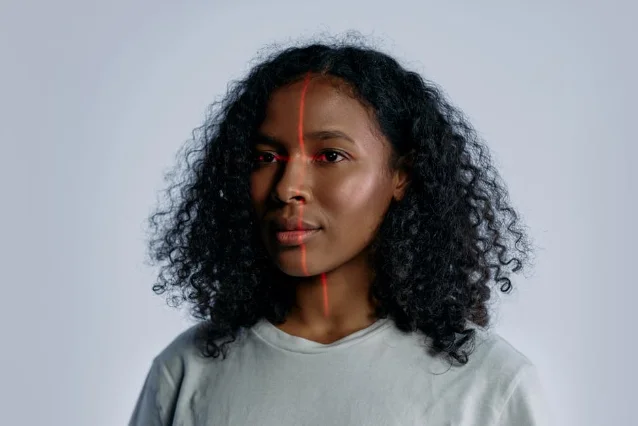 Laser scan line on a person's face illustrating body-measurement scanning technology