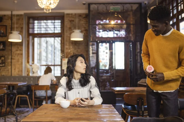 Two people on a casual first date in a café