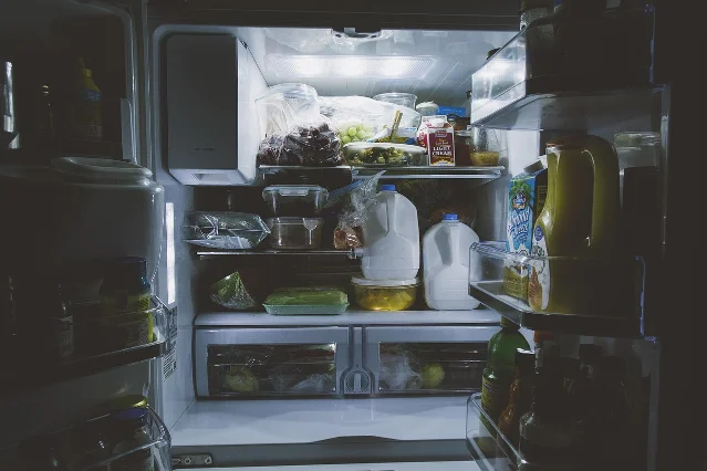 Open refrigerator shelf with organized fresh vegetables, showing proper cold storage