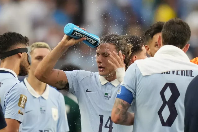 A World Cup player cools off during a hydration break