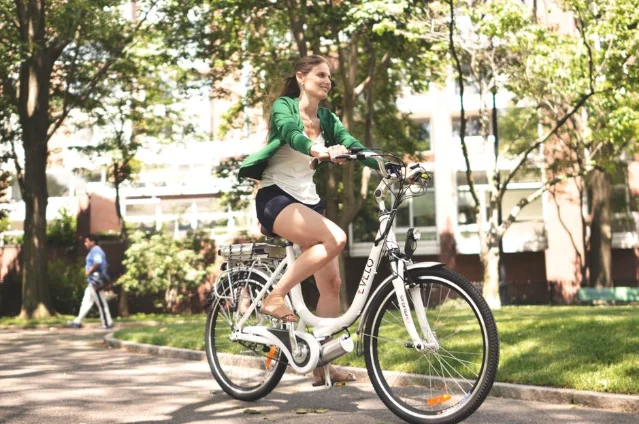 City eBike with narrow 700c tires rolling on smooth park pavement